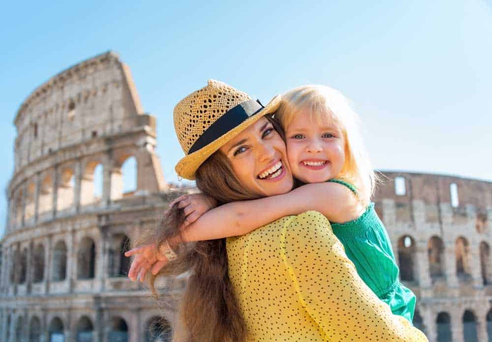 picture of mother holding daughter in front of ancient ruins