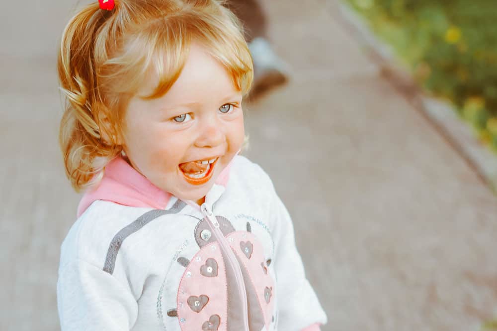 little girl smiling at camera with red hair for a blog post about middle names for Piper