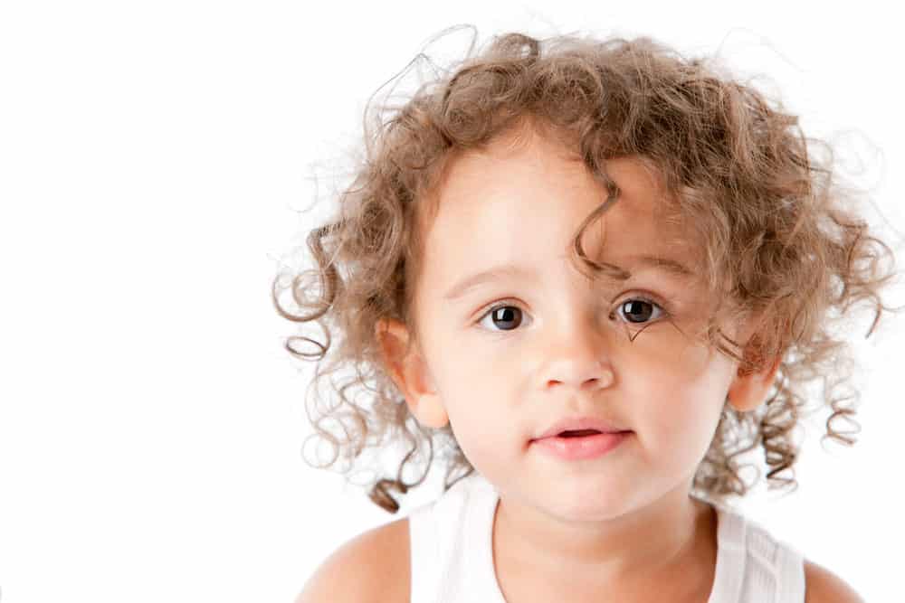 picture of toddler girl with curly hair for blog post about middle names for Valeria