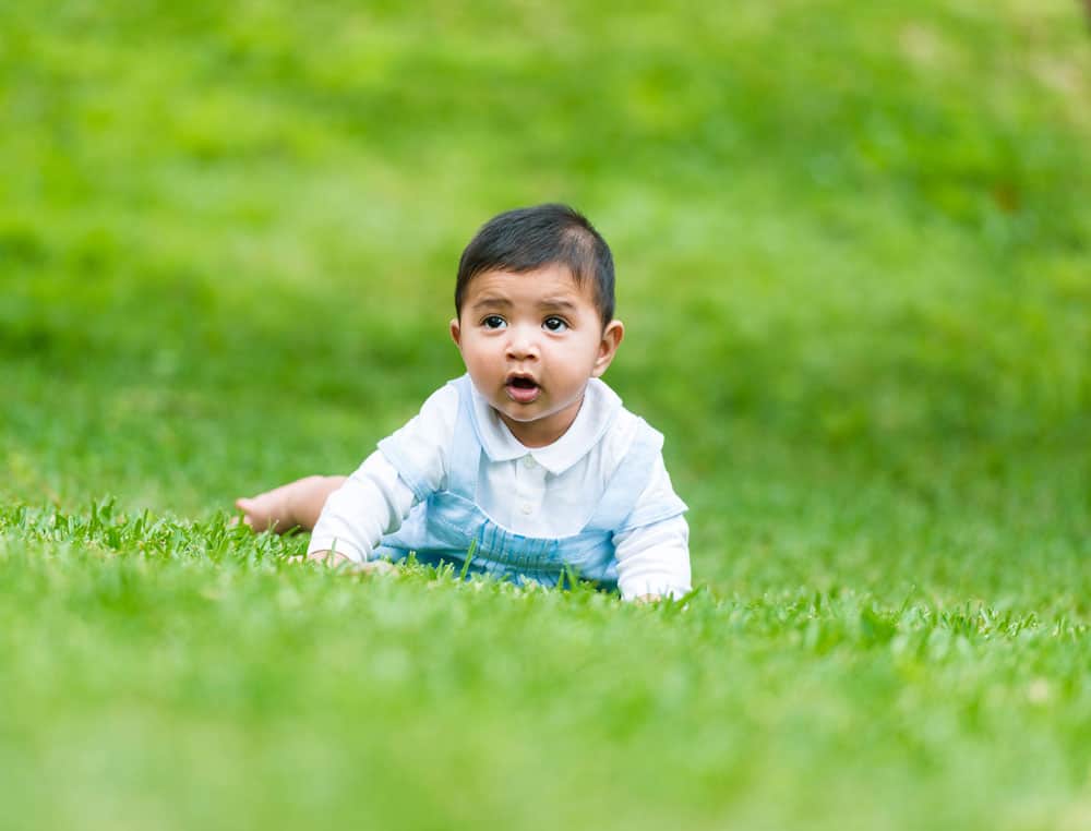 baby boy in the grass for post about middle names for xavier