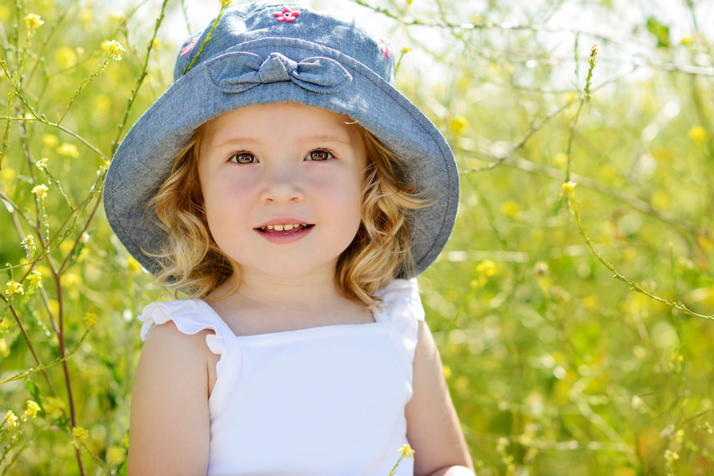 picture of little girl with hat for blog post on middle names for margot