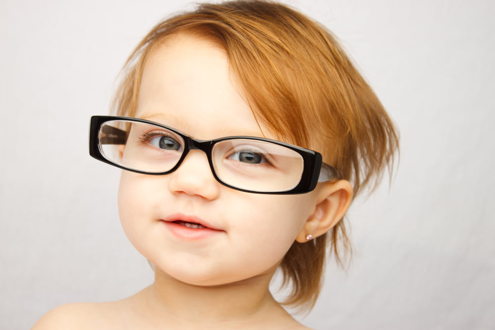 picture of toddler girl with glasses for blog post on middle names for maeve