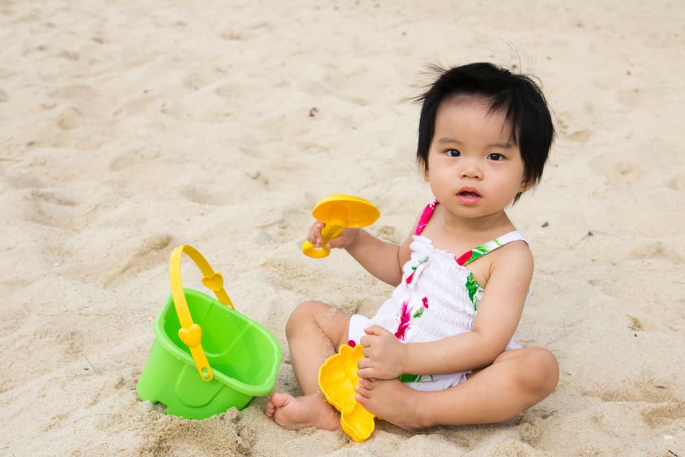 picture of toddler girl playing at the beach for blog post on middle names for Nyla