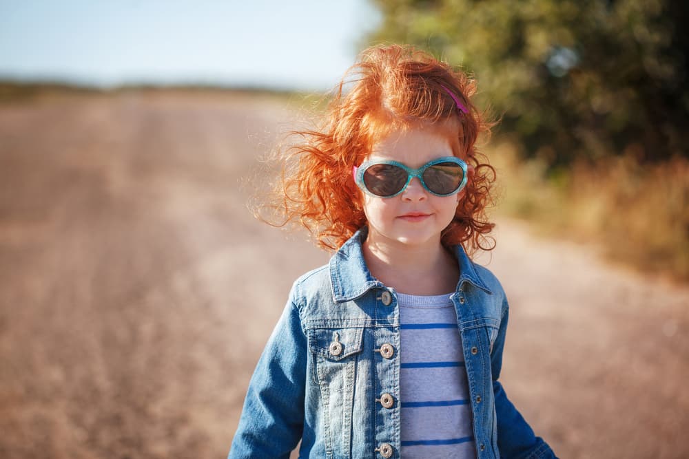 picture of red haired little girl with sunglasses on