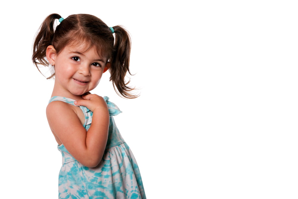 picture of toddler girl wearing a dress and hair in pigtails