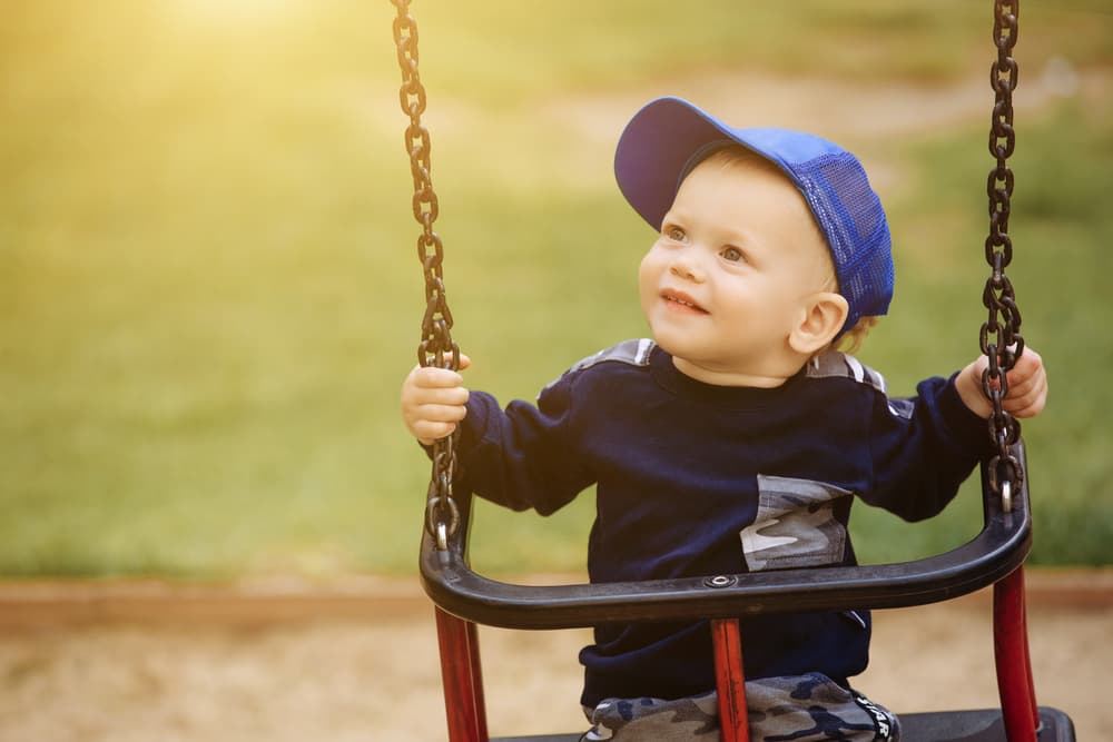 picture of toddler boy in swing
