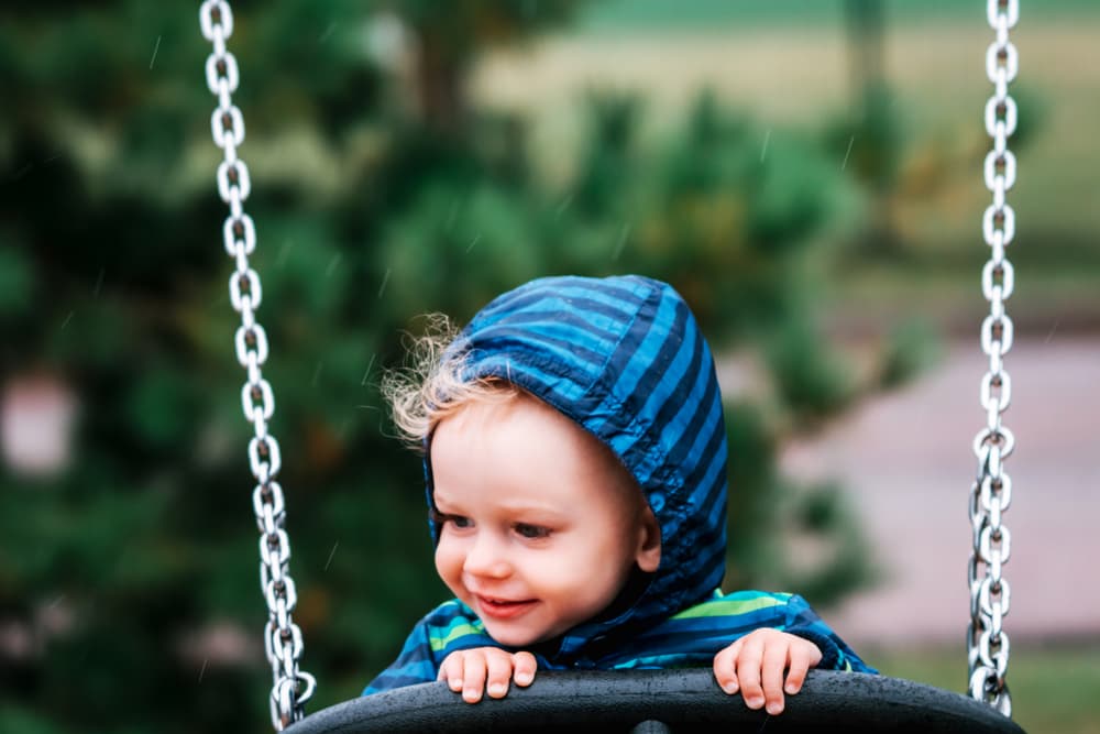 picture of toddler boy in swing