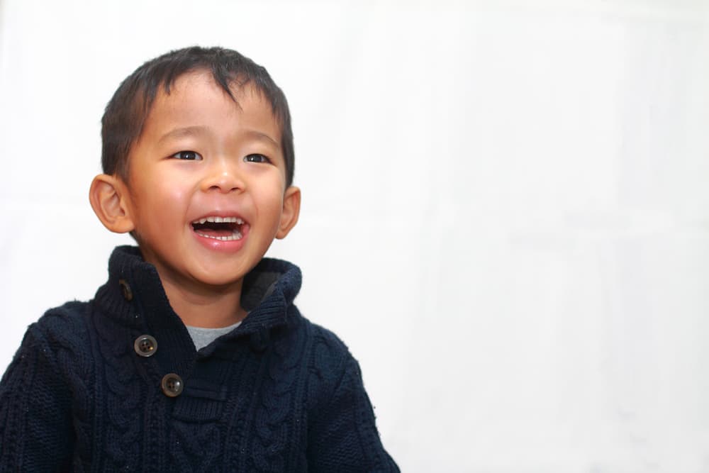 picture of smiling toddler boy in navy blue sweater