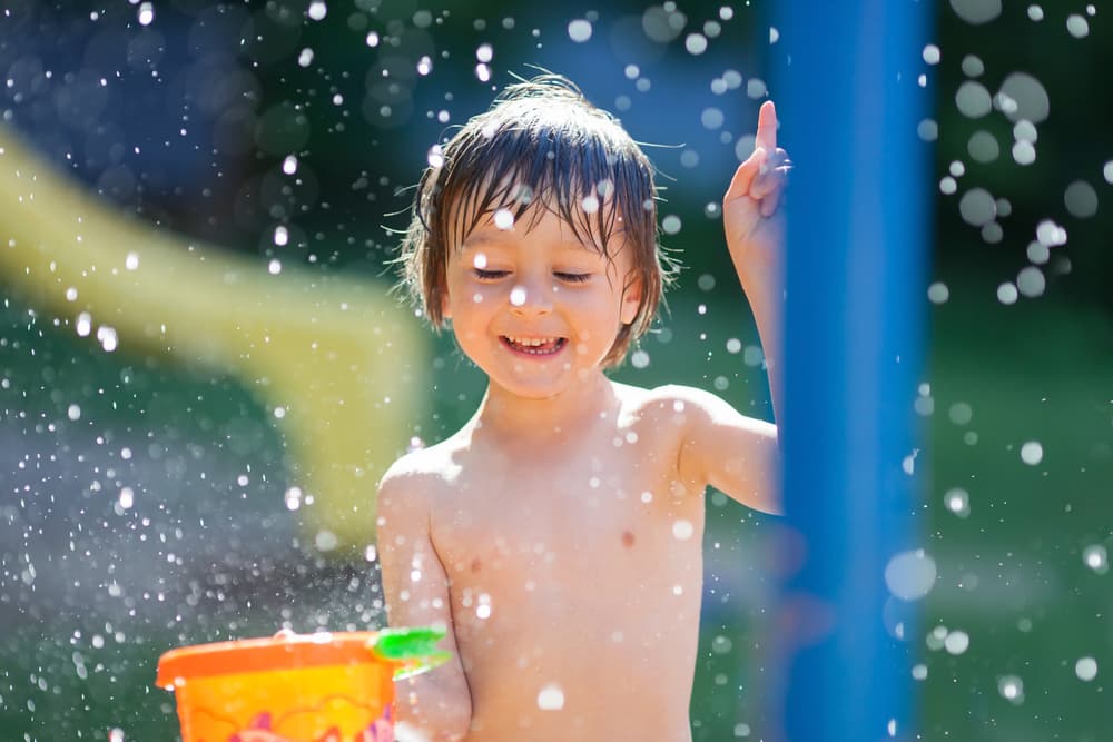 picture of little boy having fun playing in water