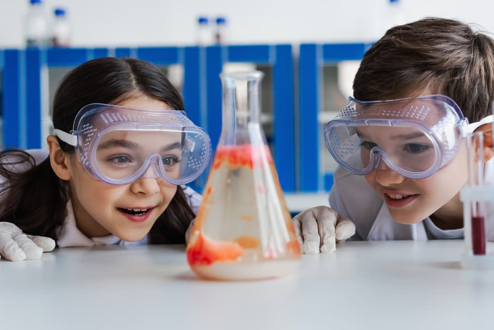 picture of boy and girl in chemistry class doing a science experiment